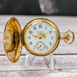 Close-up of Waltham enamel dial with black Arabic numerals and gold details